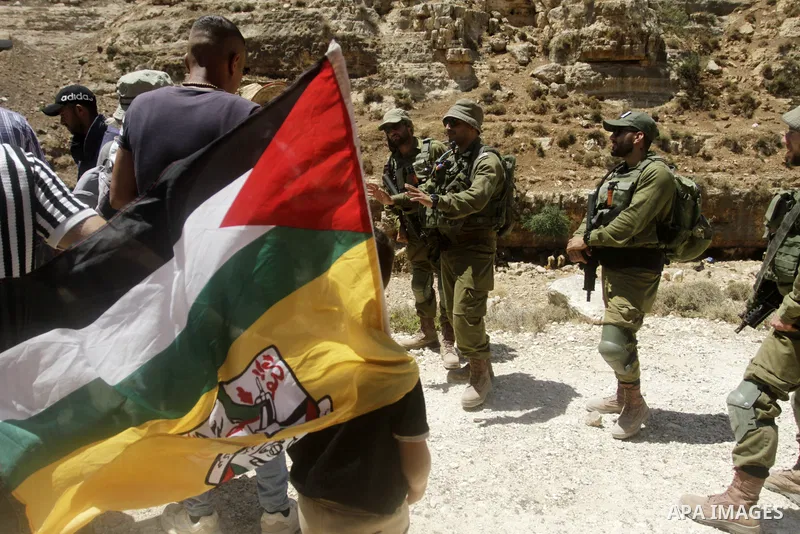 Palestinians take part in a protest following Friday prayer against settlement in the town of Deir Istiya, in the West Bank city of Salfit, on July 14, 2023. Israeli forces denied today access of Palestinian landlords in...
