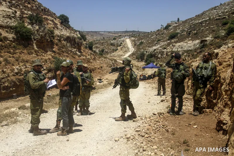 Palestinians take part in a protest following Friday prayer against settlement in the town of Deir Istiya, in the West Bank city of Salfit, on July 14, 2023. Israeli forces denied today access of Palestinian landlords in...