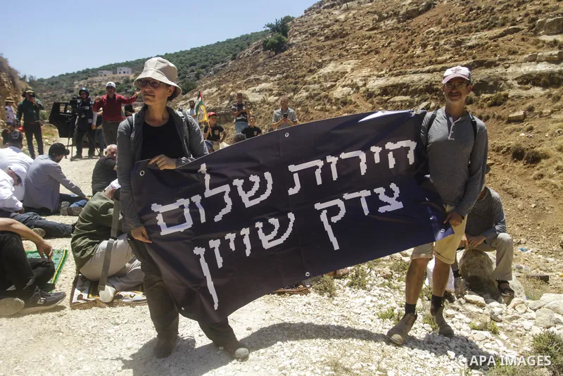 Palestinians take part in a protest following Friday prayer against settlement in the town of Deir Istiya, in the West Bank city of Salfit, on July 14, 2023. Israeli forces denied today access of Palestinian landlords in...