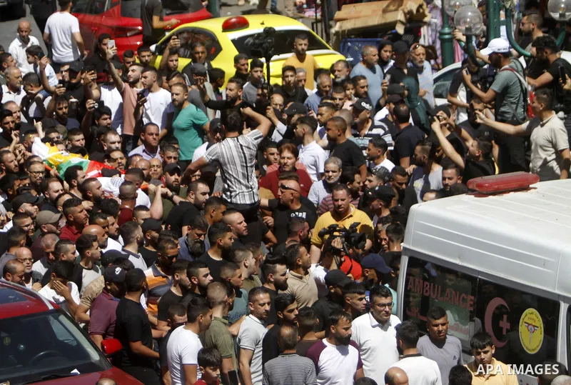 Mourners carry the body of Palestinian Bader al-Masri, who was killed while the Israeli army was securing "the coordinated entrance of Israeli civilians to Joseph's Tomb", during the funeral in the city of Nablus in the...