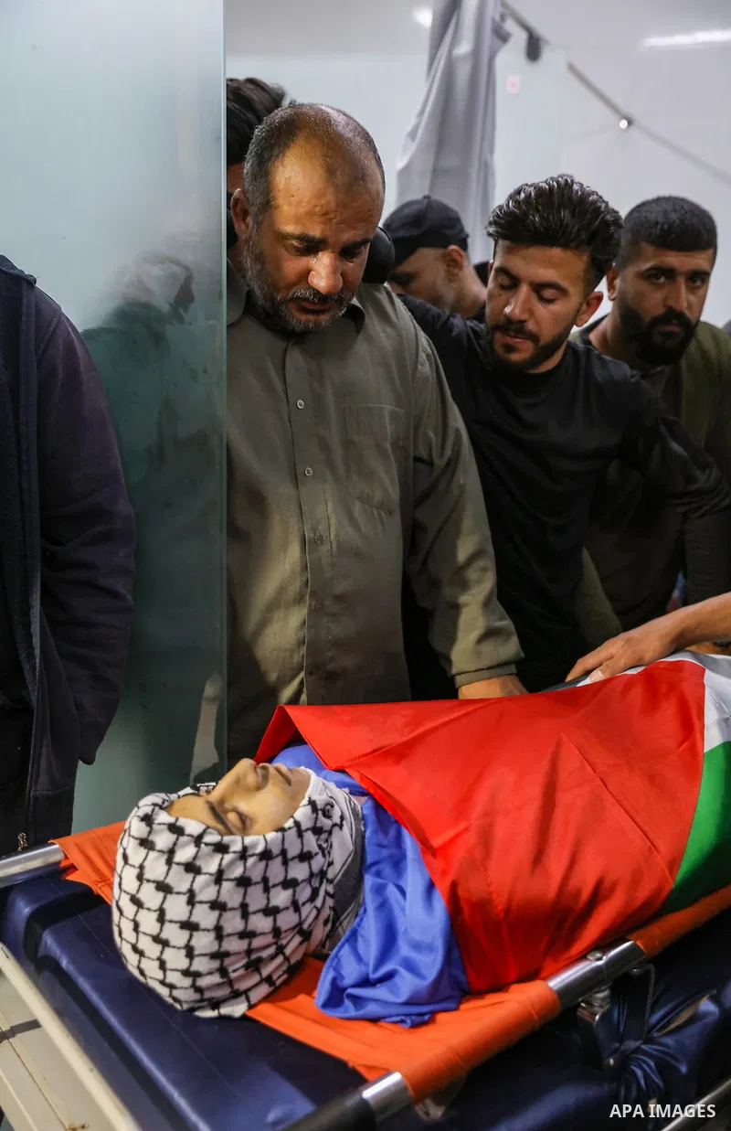 Relatives of Palestinians teenager Mustafa Amer Sabah who was shot killed by Israeli forces during clashes, mourn over his body at a hospital, in the West Bank city of Bethlehem on April 28, 2023. A sixteen-year-old Pale...