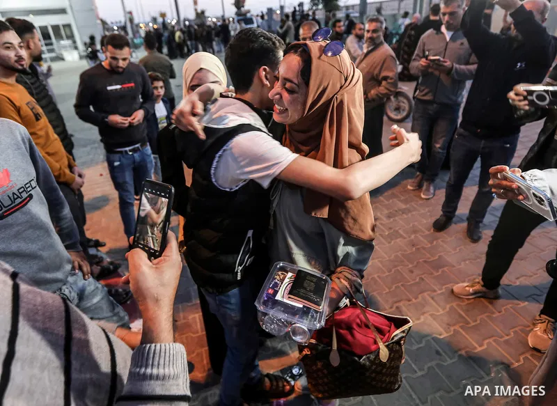 April 28, 2023, Gaza, Palestine: Palestinians greet their relatives at the gate of the Rafah crossing in the southern Gaza Strip, who were evacuated from Sudan as a result of the conflict. (Credit Image: Yousef Masoud/SO...