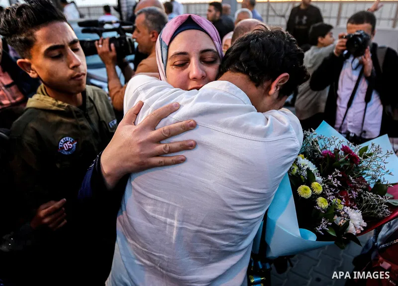 April 28, 2023, Gaza, Palestine: Palestinians greet their relatives at the gate of the Rafah crossing in the southern Gaza Strip, who were evacuated from Sudan as a result of the conflict. (Credit Image: Yousef Masoud/SO...