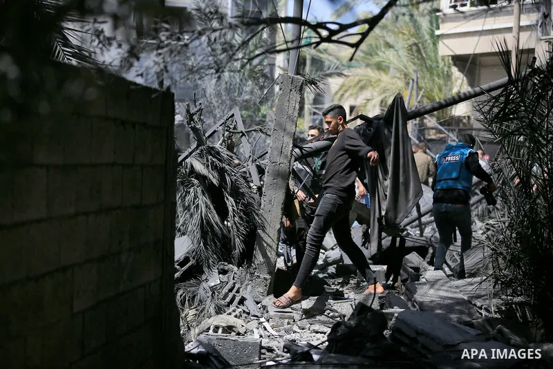 Palestinians inspect the damaged building in the aftermath of Israeli warplanes airstrikes in Beit Lahia in the northern of Gaza Strip on May 11, 2023. Israel and Gaza militants traded cross-border fire, renewing deadly...