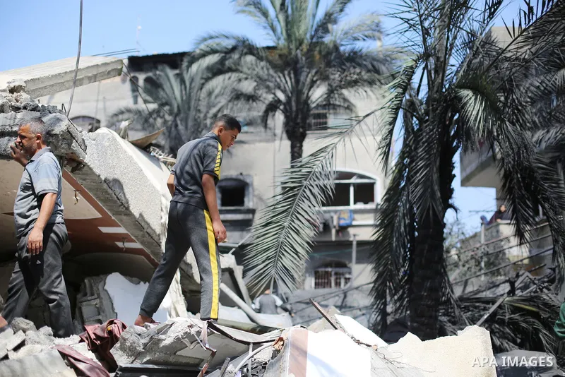 Palestinians inspect the damaged building in the aftermath of Israeli warplanes airstrikes in Beit Lahia in the northern of Gaza Strip on May 11, 2023. Israel and Gaza militants traded cross-border fire, renewing deadly...