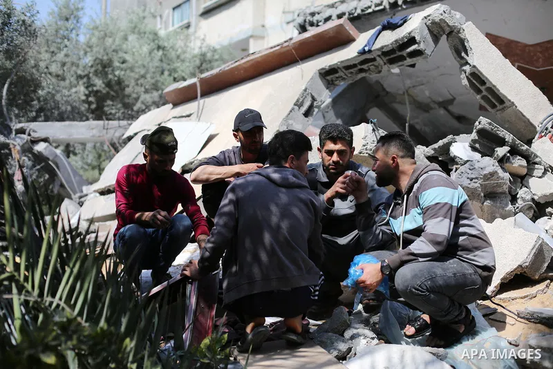 Palestinians inspect the damaged building in the aftermath of Israeli warplanes airstrikes in Beit Lahia in the northern of Gaza Strip on May 11, 2023. Israel and Gaza militants traded cross-border fire, renewing deadly...