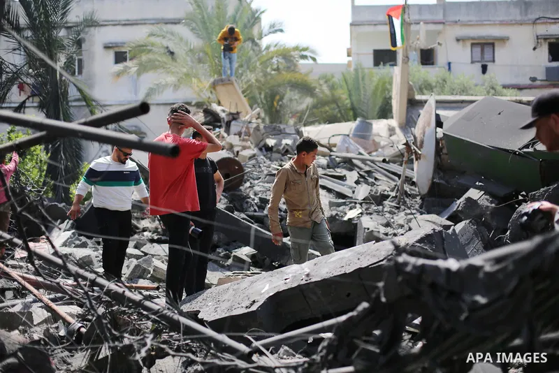 Palestinians inspect the damaged building in the aftermath of Israeli warplanes airstrikes in Beit Lahia in the northern of Gaza Strip on May 11, 2023. Israel and Gaza militants traded cross-border fire, renewing deadly...