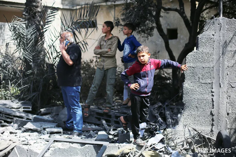 Palestinians inspect the damaged building in the aftermath of Israeli warplanes airstrikes in Beit Lahia in the northern of Gaza Strip on May 11, 2023. Israel and Gaza militants traded cross-border fire, renewing deadly...