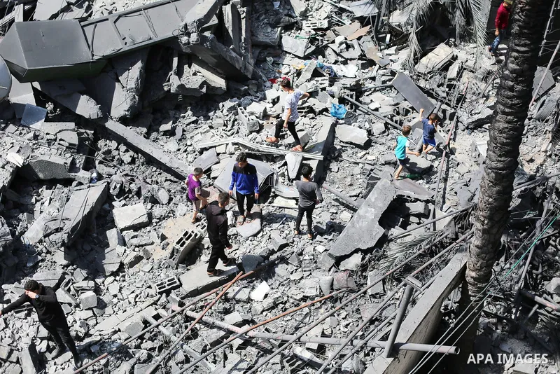 Palestinians inspect the damaged building in the aftermath of Israeli warplanes airstrikes in Beit Lahia in the northern of Gaza Strip on May 11, 2023. Israel and Gaza militants traded cross-border fire, renewing deadly...