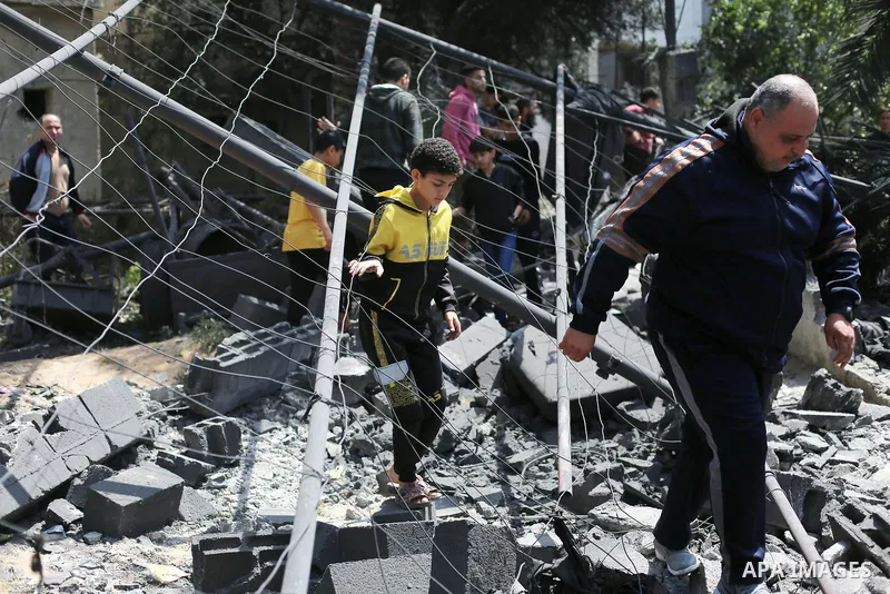 Palestinians inspect the damaged building in the aftermath of Israeli warplanes airstrikes in Beit Lahia in the northern of Gaza Strip on May 11, 2023. Israel and Gaza militants traded cross-border fire, renewing deadly...