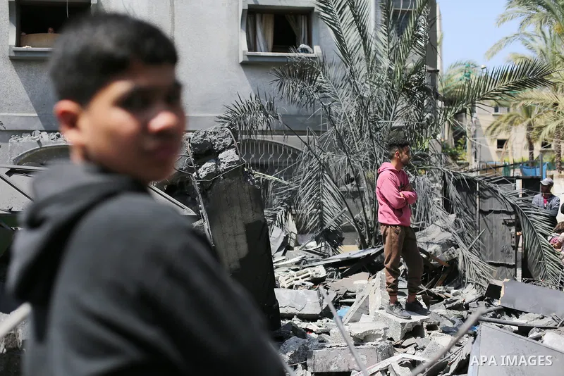 Palestinians inspect the damaged building in the aftermath of Israeli warplanes airstrikes in Beit Lahia in the northern of Gaza Strip on May 11, 2023. Israel and Gaza militants traded cross-border fire, renewing deadly...