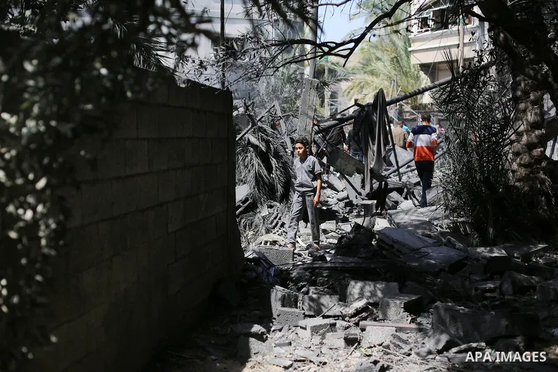 Palestinians inspect the damaged building in the aftermath of Israeli warplanes airstrikes in Beit Lahia in the northern of Gaza Strip on May 11, 2023. Israel and Gaza militants traded cross-border fire, renewing deadly...