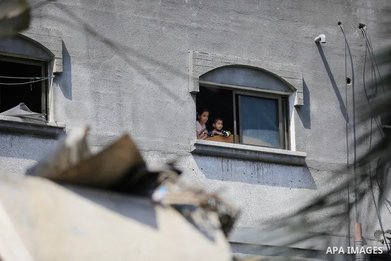 Palestinians inspect the damaged building in the aftermath of Israeli warplanes airstrikes in Beit Lahia in the northern of Gaza Strip on May 11, 2023. Israel and Gaza militants traded cross-border fire, renewing deadly...