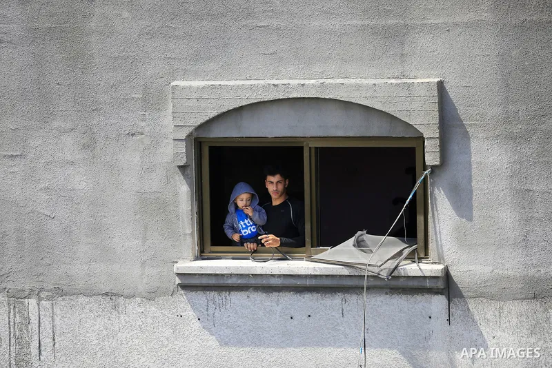 Palestinians inspect the damaged building in the aftermath of Israeli warplanes airstrikes in Beit Lahia in the northern of Gaza Strip on May 11, 2023. Israel and Gaza militants traded cross-border fire, renewing deadly...