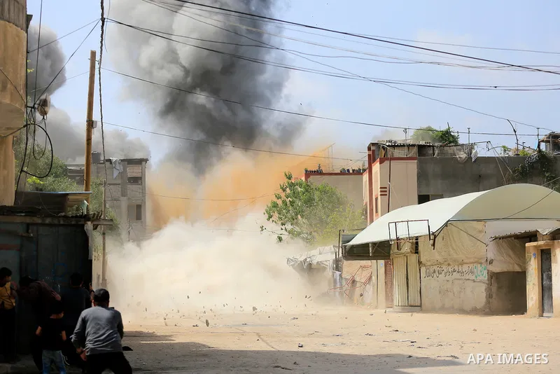 Smoke is rise from a house during an Israeli air strike in Beit Lahia in the northern Gaza Strip on May 12, 2023. Israel and Gaza militants traded heavy fire on May 12, as hopes faded of securing a truce to end days of f...