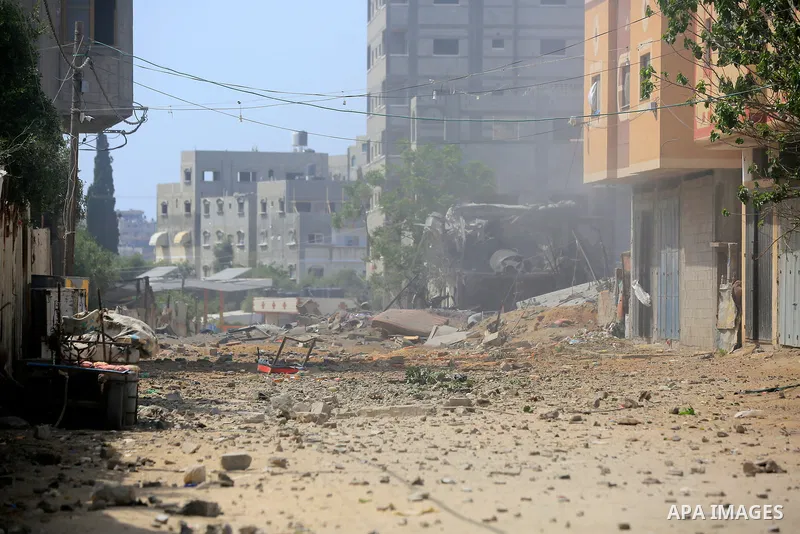 Palestinians inspect a house which was destroyed following an Israeli air strike in Beit Lahia in the northern Gaza Strip on May 12, 2023. Israel and Gaza militants traded heavy fire on May 12, as hopes faded of securing...