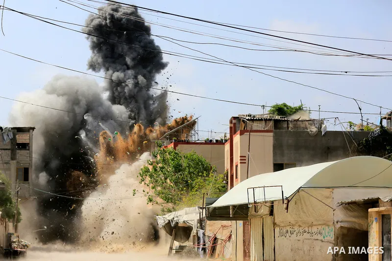 Smoke is rise from a house during an Israeli air strike in Beit Lahia in the northern Gaza Strip on May 12, 2023. Israel and Gaza militants traded heavy fire on May 12, as hopes faded of securing a truce to end days of f...