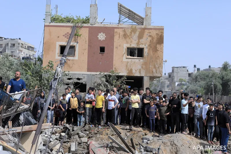 Palestinians inspect a house which was destroyed following an Israeli air strike in Beit Lahia in the northern Gaza Strip on May 12, 2023. Israel and Gaza militants traded heavy fire on May 12, as hopes faded of securing...