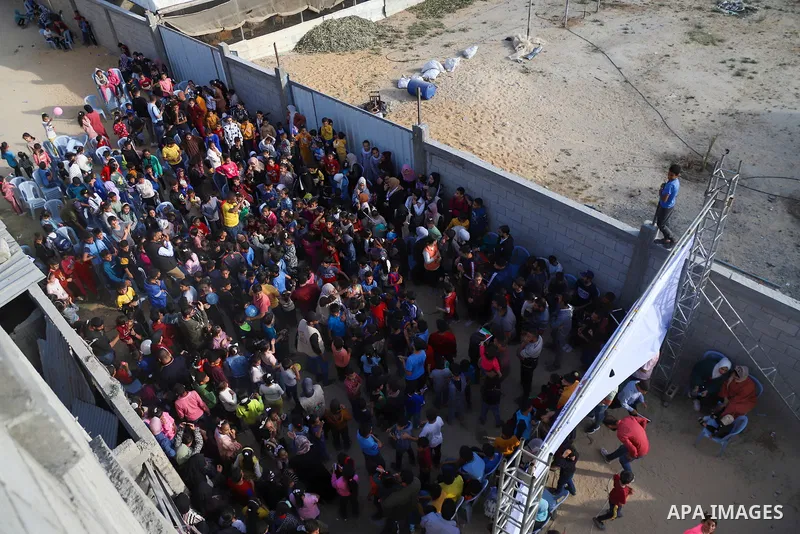Palestinian children participate in an activity, aimed to support their mental health following the recent fighting between Islamic Jihad militant group in Gaza and Israel, near the site of an Israeli airstrike in Deir A...