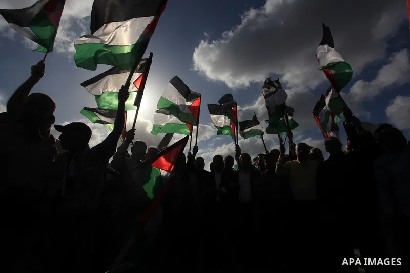Protesters gather during a Palestinian 'flag march' demonstration along the border with Israel east of Gaza city in response to the annual Israeli flag march marking 'Jerusalem Day' commemorating the old city's capture b...