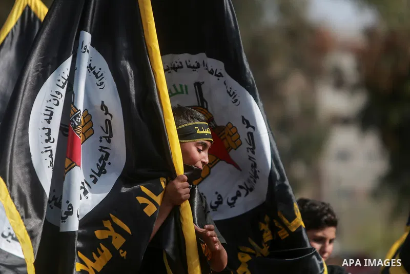Supporters of the Islamic Jihad and armed men take part in a rally to commemorate the group's commanders and operatives killed by Israel in the recent cross-border conflict, in Gaza City on May 19, 2023. Tens of people w...