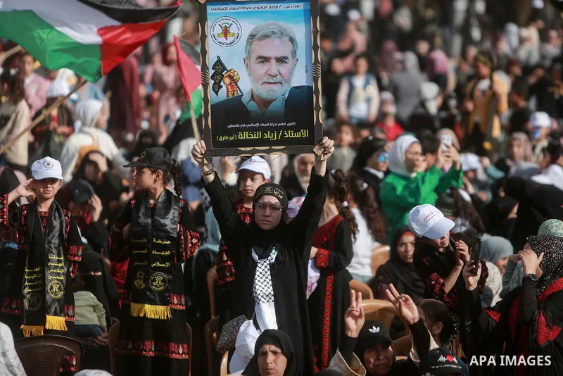 Supporters of the Islamic Jihad and armed men take part in a rally to commemorate the group's commanders and operatives killed by Israel in the recent cross-border conflict, in Gaza City on May 19, 2023. Tens of people w...