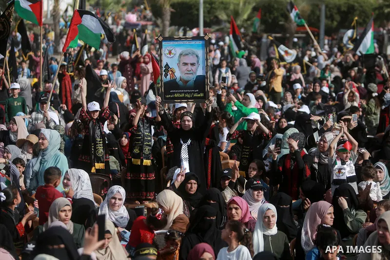 Supporters of the Islamic Jihad and armed men take part in a rally to commemorate the group's commanders and operatives killed by Israel in the recent cross-border conflict, in Gaza City on May 19, 2023. Tens of people w...