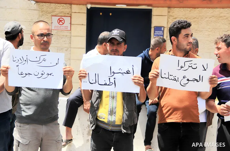 Palestinians of WFP beneficiaries take part in a protest against the stopping of aid, in front of United Nations Development Programme office (UNDP) in Gaza city on May 21, 2023. WFP pauses food distribution in Gaza foll...