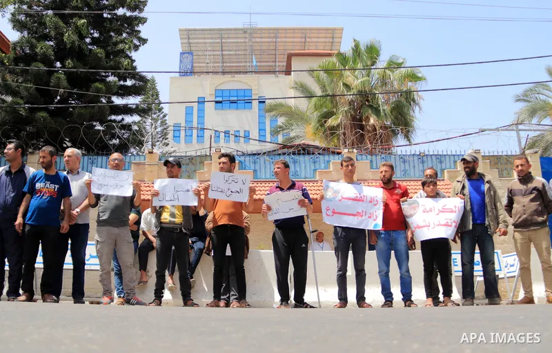 Palestinians of WFP beneficiaries take part in a protest against the stopping of aid, in front of United Nations Development Programme office (UNDP) in Gaza city on May 21, 2023. WFP pauses food distribution in Gaza foll...