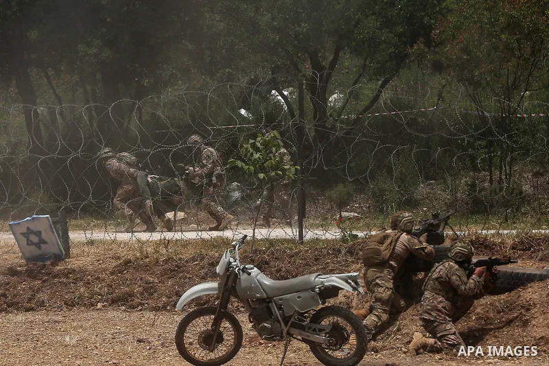 21 May 2023, Lebanon, Aramta: Pro-Iranian Hezbollah fighters conduct a simulation of abducting an Israeli soldier during a staged military exercise in a camp in the Lebanese southern village of Aramta. The show came ahea...