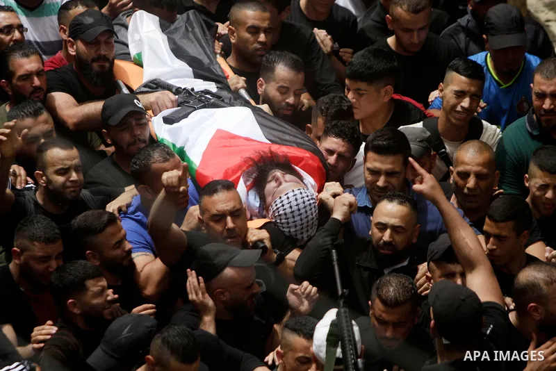 Mourners march with the bodies of Palestinians killed overnight in the Balata camp for Palestinian refugees on the outskirts of Nablus in the West Bank on May 22, 2023. Israeli forces killed three Palestinians overnight...