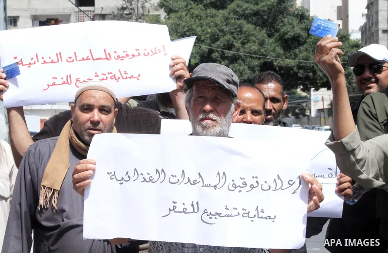 Palestinians of WFP beneficiaries take part in a protest against the stopping of aid, in front of United Nations Development Programme office (UNDP) in Gaza city on May 24, 2023. WFP pauses food distribution in Gaza foll...