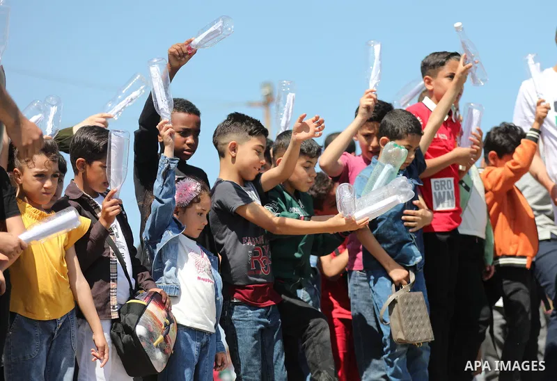 Children of Palestinian prisoners held in Israeli jails throw letters for their parents into the port of Gaza City on June 6, 2023. While the Israeli authorities prevent children from visiting their parents in jails. Ove...