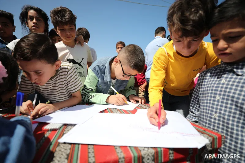Children of Palestinian prisoners held in Israeli jails throw letters for their parents into the port of Gaza City on June 6, 2023. While the Israeli authorities prevent children from visiting their parents in jails. Ove...