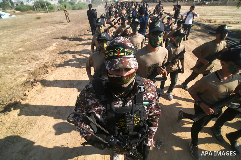 Palestinian youths brandishing fake rifles, parade during a military-style summer camp, organised annually by the Islamic Jihad movement during the school holiday, in Khan Yunis in the southern Gaza Strip, on June 22, 20...
