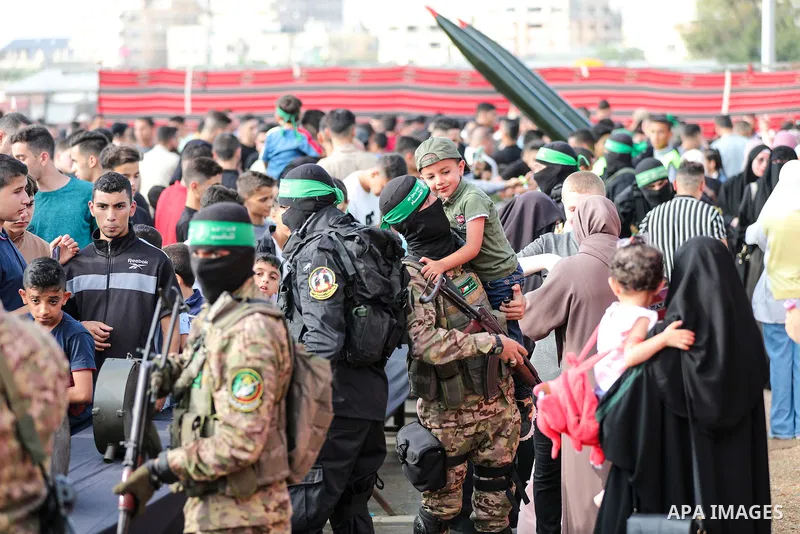 Palestinians attend a weapons exhibition organized by the Al-Qassam Brigades, the military wing of Hamas, in Nuseirat, central Gaza Strip, on the third day of Eid al-Adha on June 30, 2023. “Ezzedeen Al-Qassam Brigades” i...