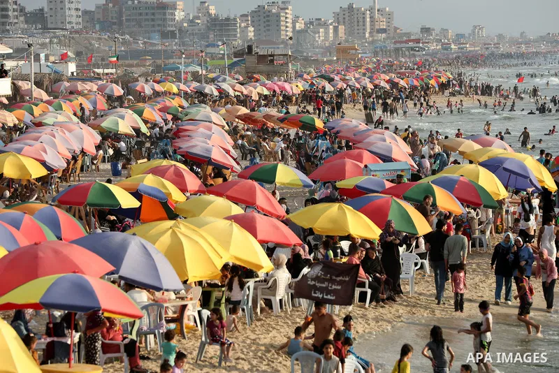 Palestinians gather on the Gaza sea's beach on the third day of Eid al-Adha on June 30, 2023. Known as the "big" festival, Eid al-Adha, or Feast of Sacrifice, is celebrated each year by Muslims sacrificing various animal...