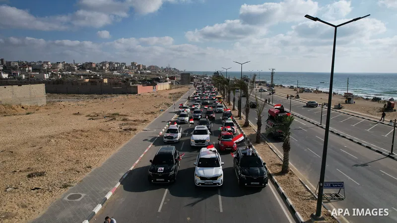 Palestinians carry the Egyptian flags and portraits of Egyptian President Abdel Fattah El-Sisi on the "Egypt" Corniche, which was built by the Arab Republic of Egypt in the northern Gaza Strip on June 30, 2023.. Photo by...