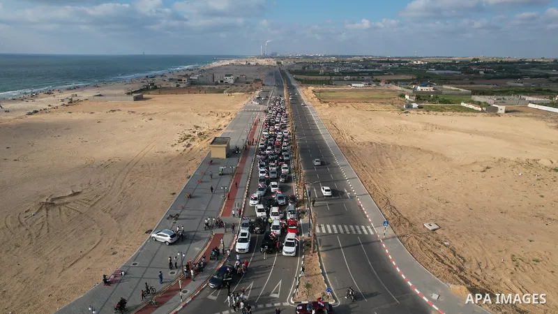 Palestinians carry the Egyptian flags and portraits of Egyptian President Abdel Fattah El-Sisi on the "Egypt" Corniche, which was built by the Arab Republic of Egypt in the northern Gaza Strip on June 30, 2023.. Photo by...