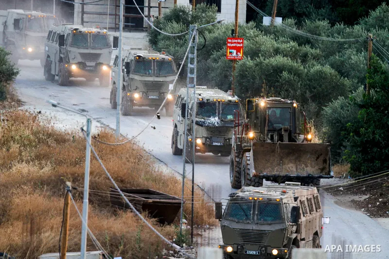 Israeli military vehicles advance on a street during an ongoing Israeli military operation in Jenin city in the West Bank, on July 4, 2023. Israel pushed on for a second day on July 4 with its biggest military operation...