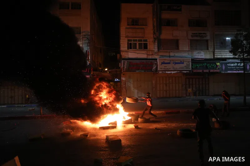 Palestinian protesters clash with Israeli forces following a demonstration in the West Bank city of Hebron protesting an Israeli military operation in Jenin for the second day, on July 4, 2023. Eight Palestinians were sh...
