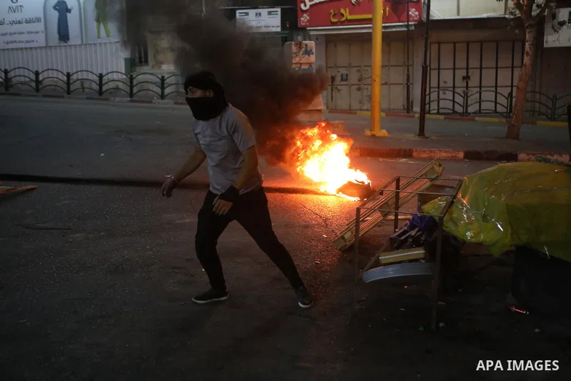 Palestinian protesters clash with Israeli forces following a demonstration in the West Bank city of Hebron protesting an Israeli military operation in Jenin for the second day, on July 4, 2023. Eight Palestinians were sh...