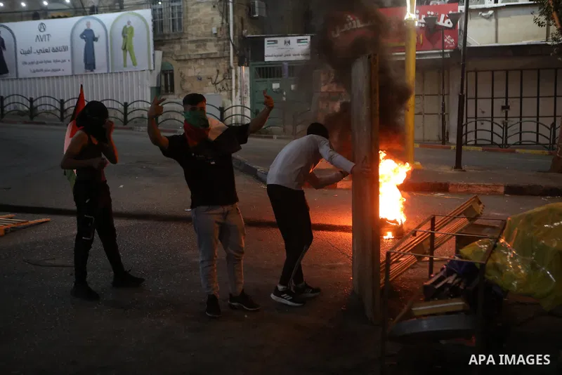 Palestinian protesters clash with Israeli forces following a demonstration in the West Bank city of Hebron protesting an Israeli military operation in Jenin for the second day, on July 4, 2023. Eight Palestinians were sh...