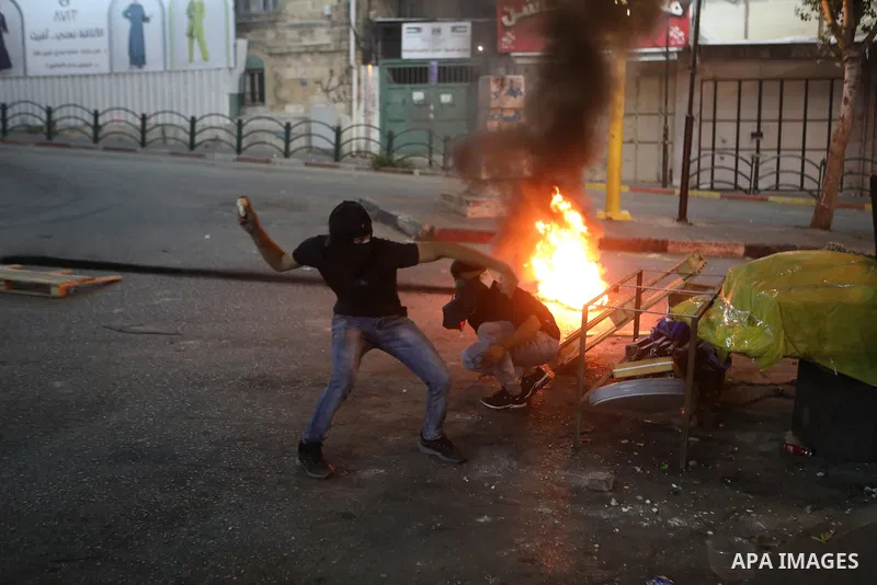 Palestinian protesters clash with Israeli forces following a demonstration in the West Bank city of Hebron protesting an Israeli military operation in Jenin for the second day, on July 4, 2023. Eight Palestinians were sh...