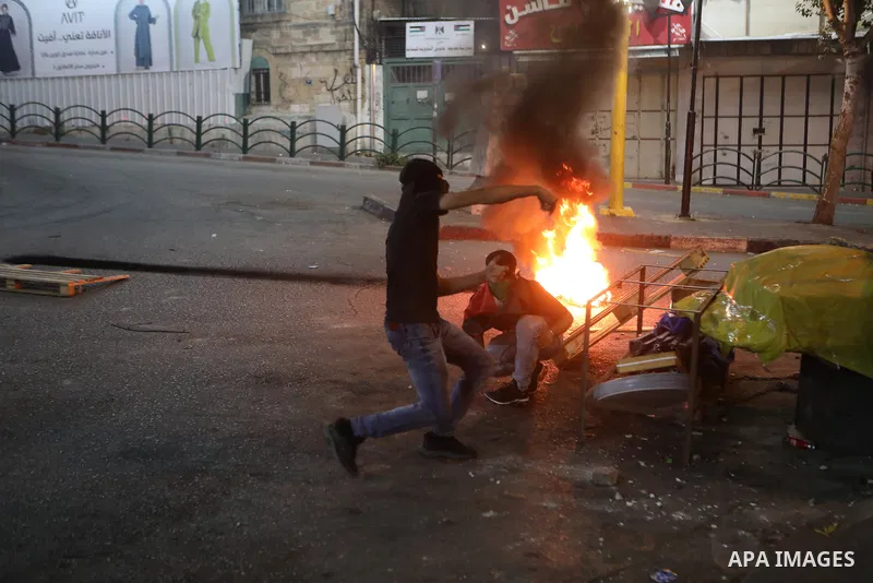 Palestinian protesters clash with Israeli forces following a demonstration in the West Bank city of Hebron protesting an Israeli military operation in Jenin for the second day, on July 4, 2023. Eight Palestinians were sh...