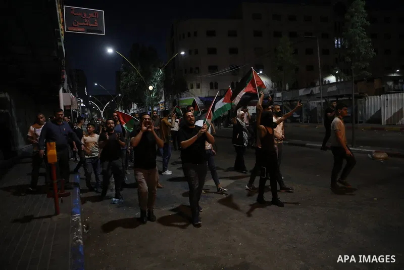 Palestinians shout slogans and hold placards during a demonstration in the West Bank city of Hebron protesting an Israeli military operation in Jenin for the second day, on July 4, 2023. Eight Palestinians were shot and...