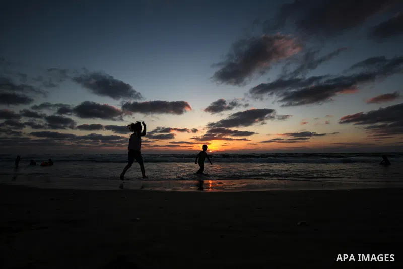 Palesinians enjoy their time on the beach of Gaza city during sunset on July 5, 2023. Photo by Omar Ashtawy\ apaimages