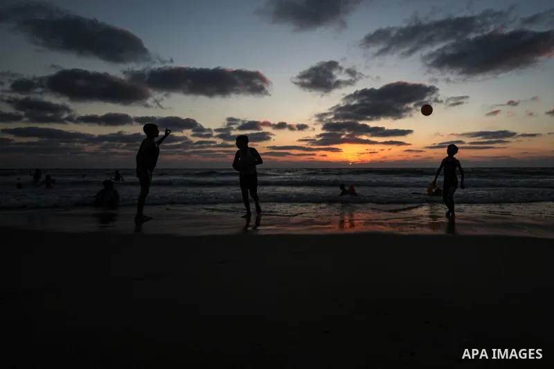 Palesinians enjoy their time on the beach of Gaza city during sunset on July 5, 2023. Photo by Omar Ashtawy\ apaimages
