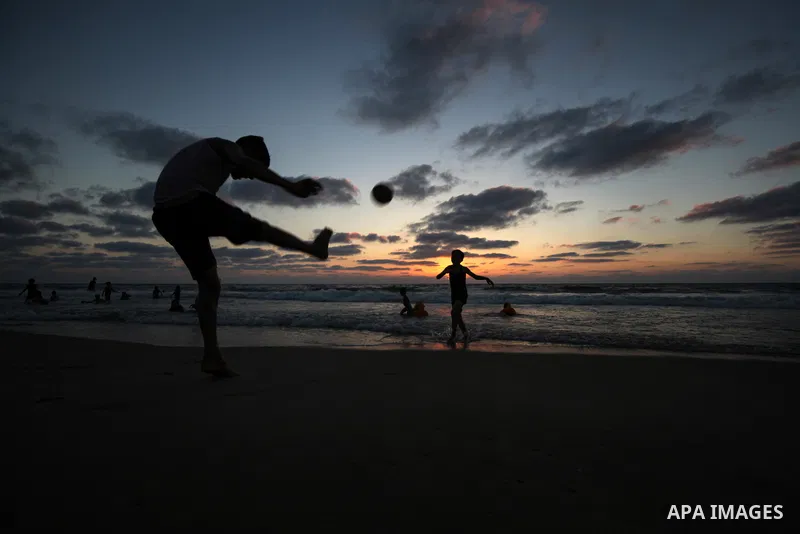 Palesinians enjoy their time on the beach of Gaza city during sunset on July 5, 2023. Photo by Omar Ashtawy\ apaimages