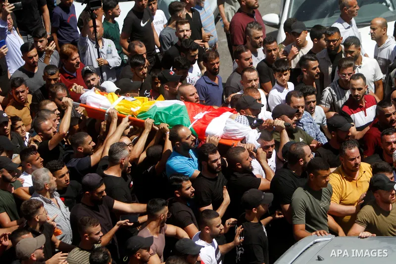 Mourners carry the body of Palestinian Bader al-Masri, who was killed while the Israeli army was securing "the coordinated entrance of Israeli civilians to Joseph's Tomb", during the funeral in the city of Nablus in the...